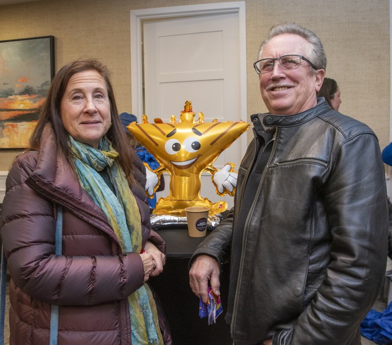 Lewes residents Renee and Wayne Casanova gather near the animated menorah to celebrate the light of Hanukkah.